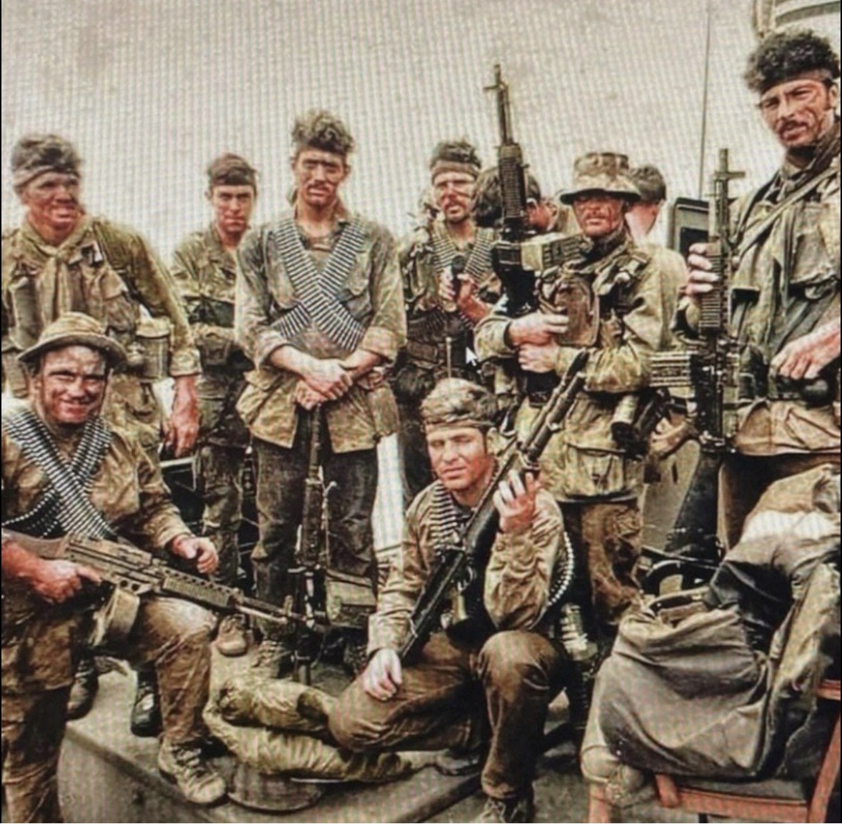 Archive photograph of a Vietnam-era reconnaissance team assembled with their equipment after an operation.